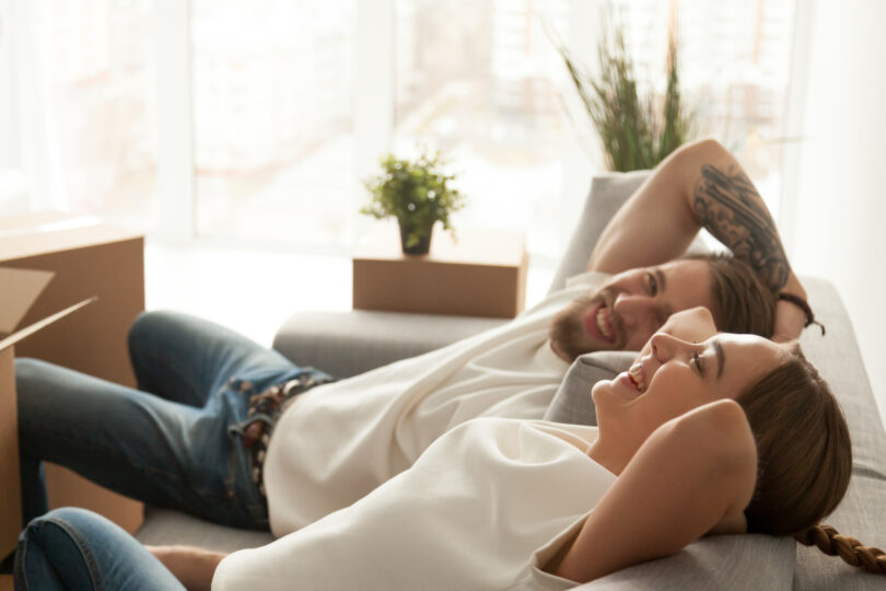 happy young couple relaxing in their new home