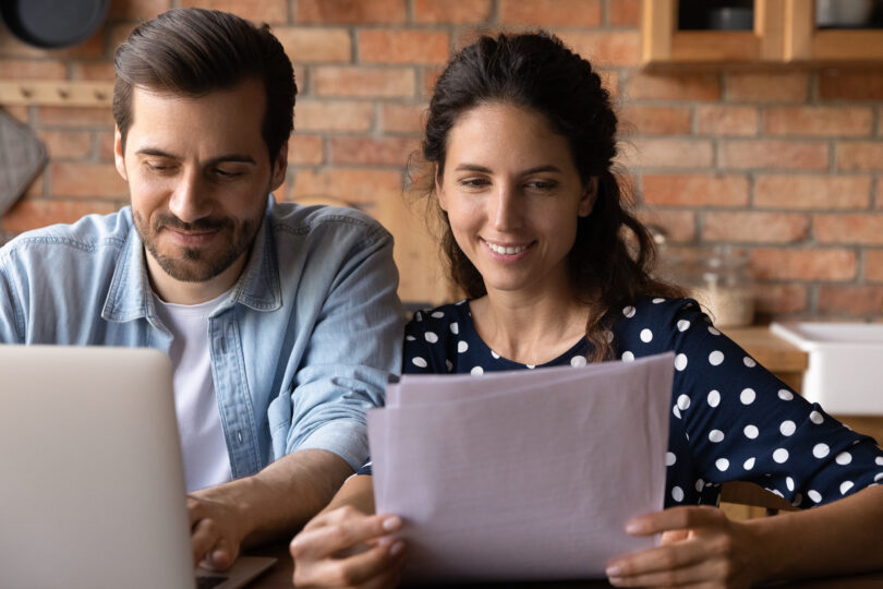 Couple sitting at table budgeting for a house deposit in the UK