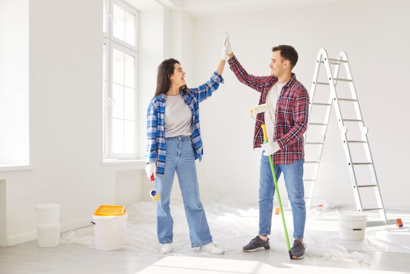 UK homeowner happy decorating home after securing a fast mortgage further advance